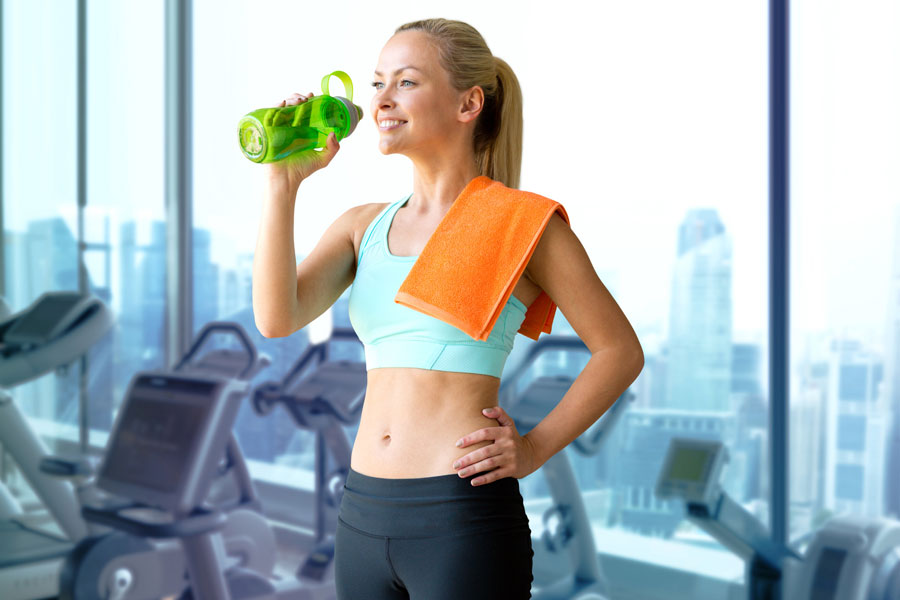 woman drinks filtered water in gym
